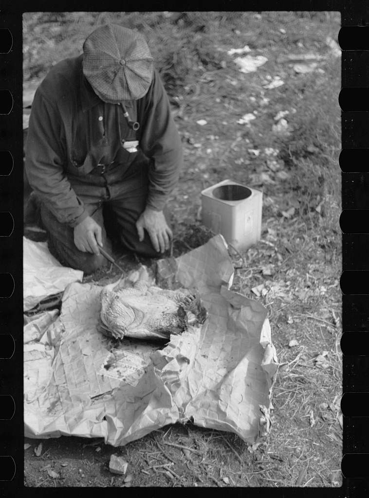 Man in a Minneapolis hobo jungle killing a turtle to make soup